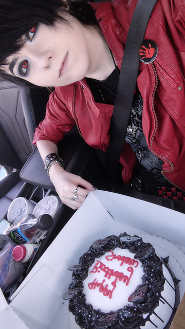 Pale emo with birthday cake on their lap.
