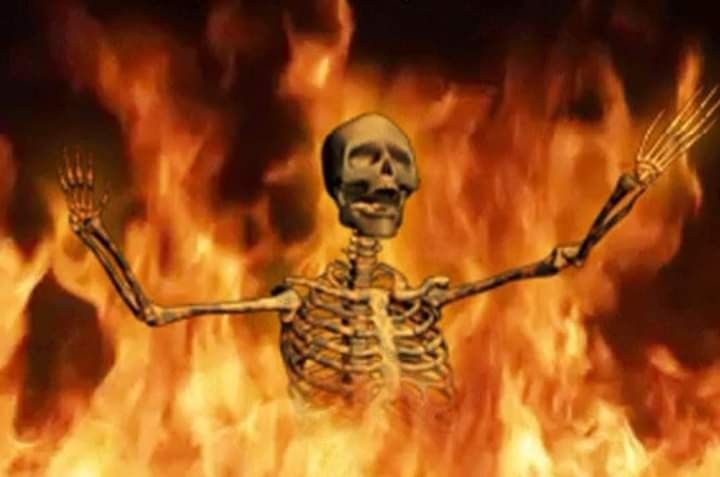 This may contain: a skeleton standing in front of a fire with arms and legs stretched out, holding two forks