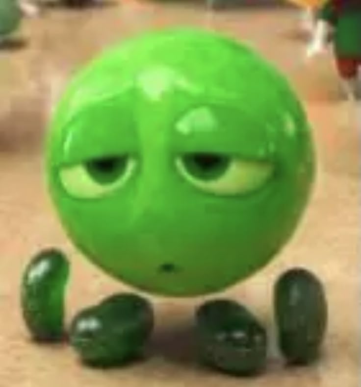 This may contain: a green ball with eyes and legs sitting in front of other balls on the ground