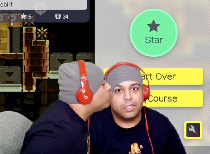 This may contain: a man with headphones on is looking at another person's earpieces