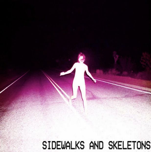 This may contain: a person standing on the side of a road at night