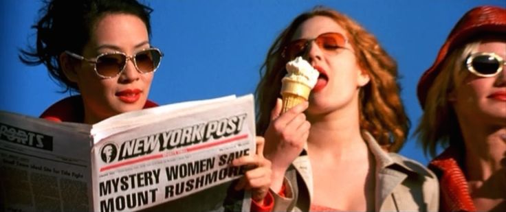 This may contain: three women in sunglasses are eating ice cream and reading the news paper while wearing sun glasses