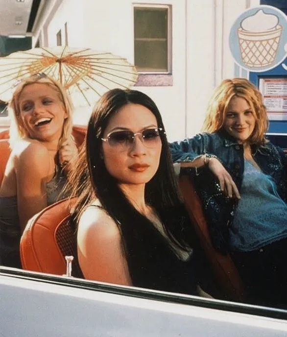 This may contain: three women sitting in the back of a car
