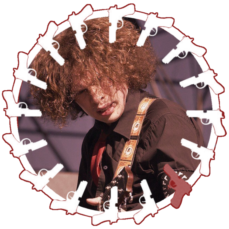 Revenge Era Ray Toro surrounded by a ring of guns. He is wearing a black button up and red tie, his hair partially covering his face. He is leaning over, playing the guitar with a focused expression.
