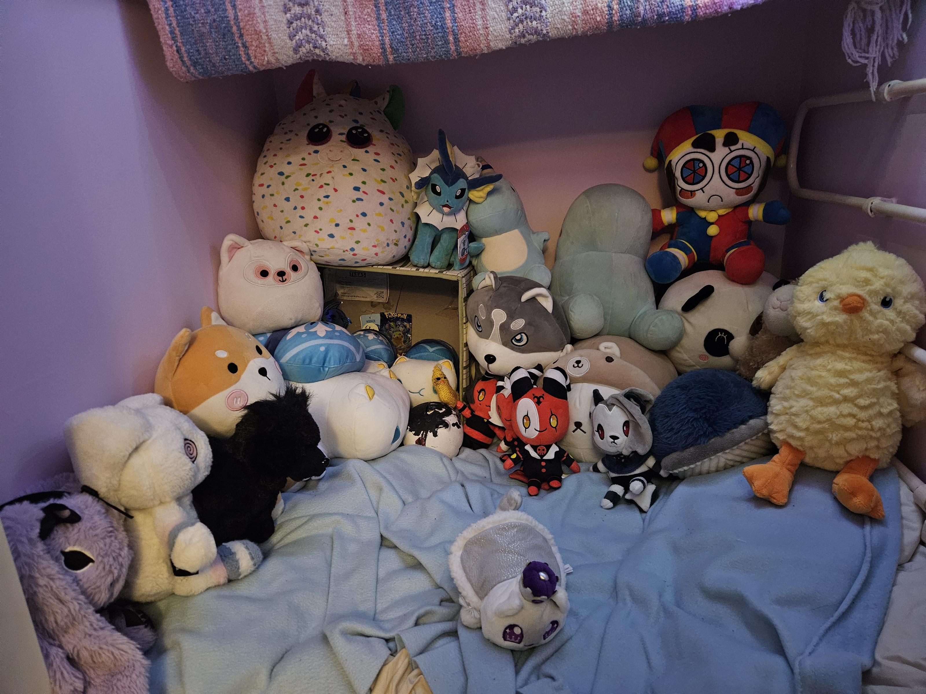 A Vast closet full of plushies from top to bottom: a rainbow blob,a chubby hippo, two cuddling meerkats,a large shark,a very small crocheted dragon,a beige blob with a cat face wearing a tin foil hat, a small more realistic cat,a large plush of luna from helluva boss, a blob that looks like a bat, a large mushroom, a warrior cats plush,a blue cat with a yellow backpack,a wooloo plushie, a blob shiba inu, a yellow bunny, a bright purple crocheted bee and a yellow non crocheted bee, a small seal, a anthro deer, a anthro pink unicorn girl,a blob with rainbow spots,a vapoureon, a small blue dinosaur, a larger blue dinosaur, pomni from the digital cirus, a blob panda, a fluffy duck, a purple goth bunny, a white and pink bunny, a black dog, a shiba inu in a green bandana, a white and pink blob cat, three white cats with blue patterned backpacks one big and two small, very small plushies of chibi verisons of the helluva boss cast, a blue whale and a small white cat in a regal coat and crown