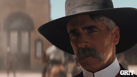 sam elliot (white haired cowboy)tipping his cowboy hat @ you