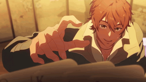 a man with red hair is pointing his finger at the camera
