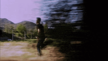 a blurry photo of a man running in a field