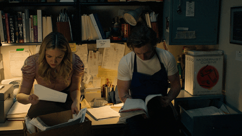 people fromt the tv show bear looking through files